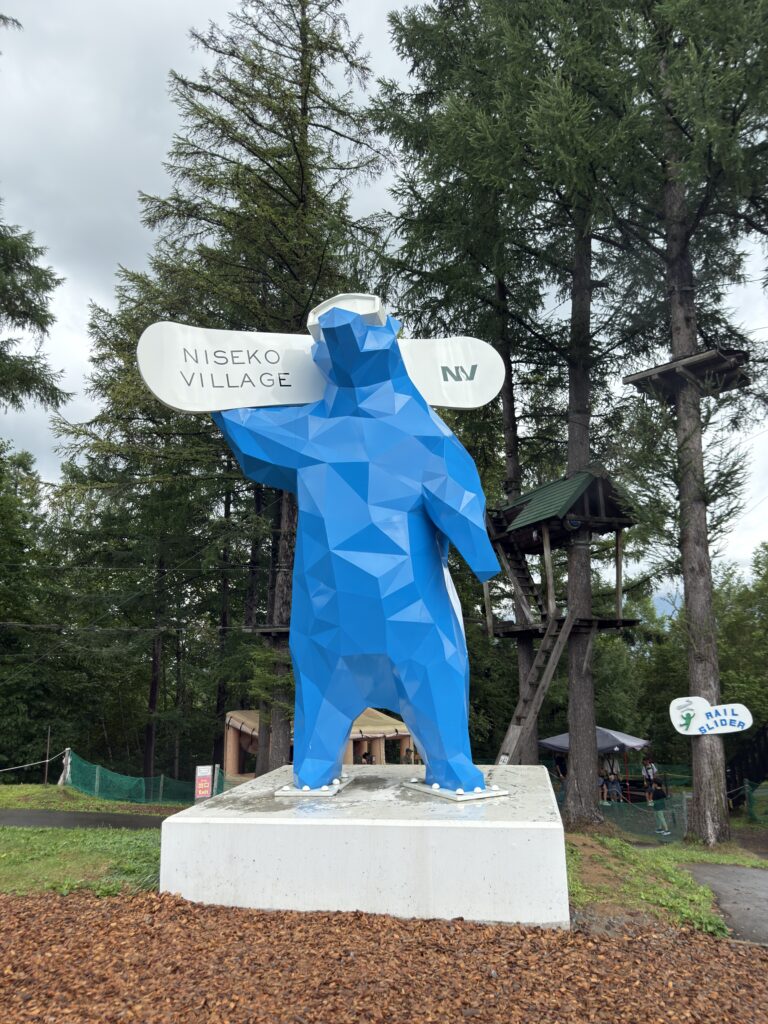 Blue bear monument at Niseko Village entrance, symbolic photo spot near Annupuri resorts and family attractions in Niseko Hokkaido