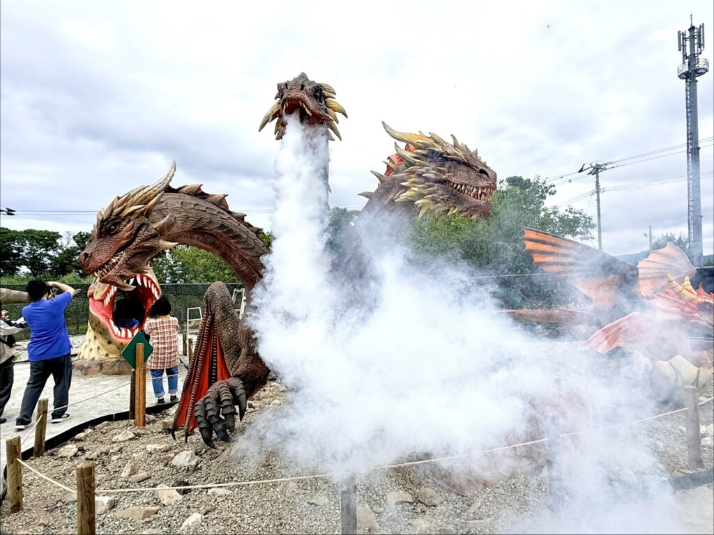 Dragon statue breathing smoke at Nitori Yoichi Dinosaur Park in Hokkaido, Japan