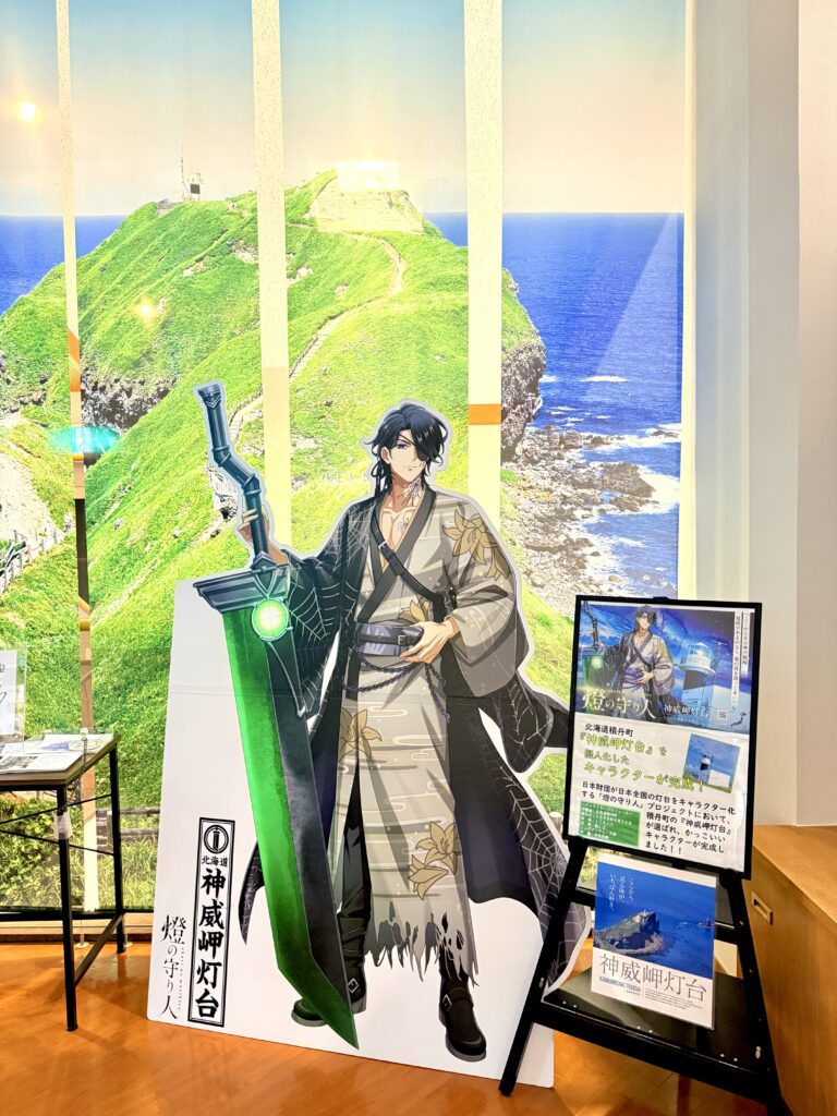 Cape Kamui Lighthouse character display with Cape Kamui and the Shakotan Blue sea in the background